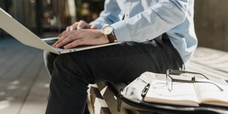 executive using laptop outdoors