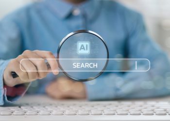 Businessmen use computers and magnifying glasses with AI search engine bars for data search optimization by artificial intelligence technology. Ai search concept.