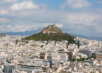 An aerial view of buildings and hills in Athens, Greece