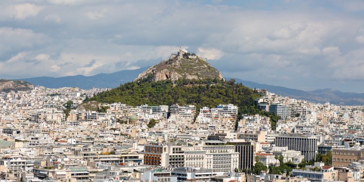 An aerial view of buildings and hills in Athens, Greece