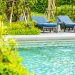 Beautiful outdoor swimming pool in hotel and resort with chair and deck for leisure vacation and travel