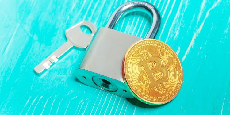 Gold bitcoin and padlock