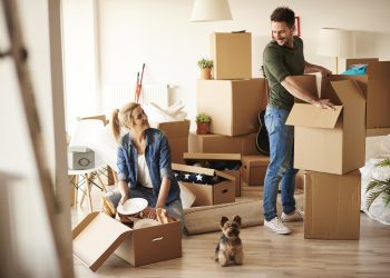 Young couple in new apartment with small dog