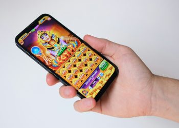 Photo of a person playing a slot game on a smartphone