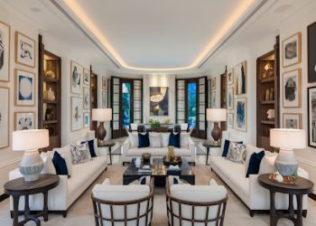 The image showcases a sophisticated and elegant living room interior featuring a harmonious blend of high-end wall art in various styles such as Coastal, Black & White, Abstract, and Vintage, displayed in premium frames, complemented by plush furniture, soft lighting, and tasteful decor, creating a warm and inviting atmosphere that exudes style, quality, and accessibility for mid to upper mid-market consumers in the USA.