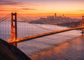 The iconic Golden Gate Bridge and SF skyline viewed from the Marin Headlands at sunset.