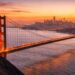 The iconic Golden Gate Bridge and SF skyline viewed from the Marin Headlands at sunset.