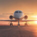 Private jet on an airport runway during a stunning sunset.