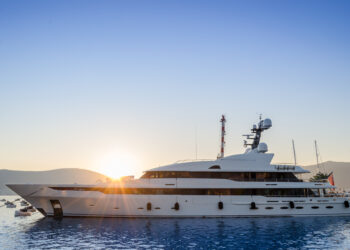 Beautiful white yacht in the port of the Adriatic sea, at sunset.