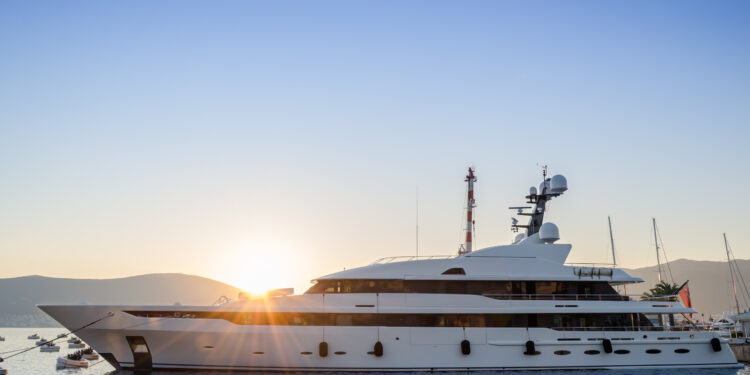 Beautiful white yacht in the port of the Adriatic sea, at sunset.