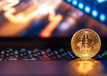 Bitcoin coin on keyboard with nice background. Crypto money concept. High quality photo