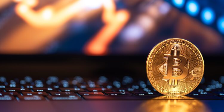 Bitcoin coin on keyboard with nice background. Crypto money concept. High quality photo