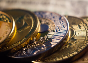 a closeup shot of a pile of cryptocurrency cash golden coins