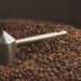 Dark, aromatic, chocolate coffee beans freshly baked and hot cool dawn inside the best professional roasting machine close up focus