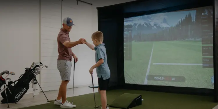 Father and son indoor golf simulator.