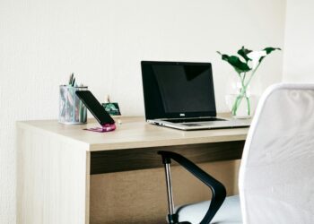Laptop computer on wooden desk.