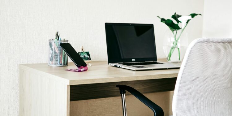 Laptop computer on wooden desk.