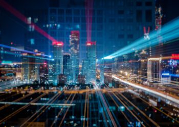 Light trails above buildings at night in China.