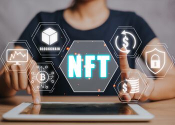 NFT token digital crypto art blockchain technology concept, Person hand using digital tablet with NFT icon on virtual screen.