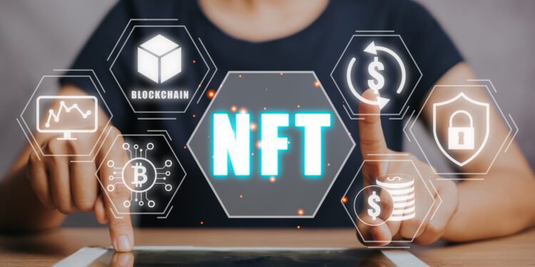 NFT token digital crypto art blockchain technology concept, Person hand using digital tablet with NFT icon on virtual screen.