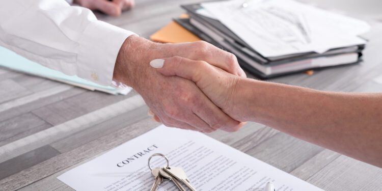 Handshake between estate agent and customer