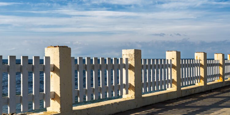 An old embankment along the seashore, a sky with wisps of cloud, a natural concept awaiting the winter storm season