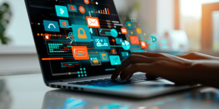 Software developer working on laptop with augmented reality software development interface