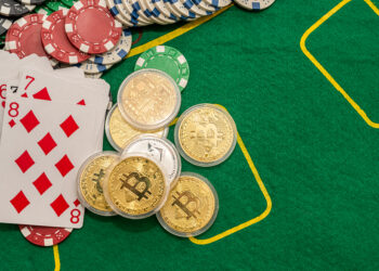 Poker new cards with various chips and money are laid out on a green playing poker table. Poker concept. Game concept