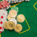 Poker new cards with various chips and money are laid out on a green playing poker table. Poker concept. Game concept