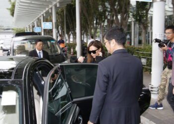Discreet executive protection professional coordinating secure travel for a family office principal