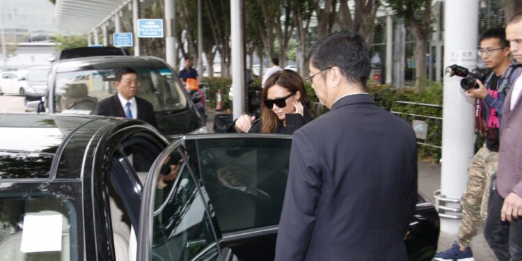 Discreet executive protection professional coordinating secure travel for a family office principal