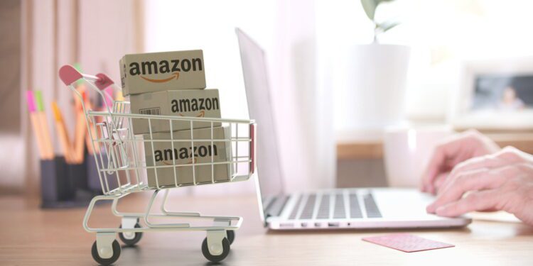 Boxes in shopping cart near the laptop. Editorial 3D