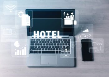 Digital Hotel Management Concepts with Laptop and Smartphone Displaying Icons Related to Reservation, Services, and Guest Experience in Modern Hospitality Quark.