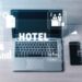 Digital Hotel Management Concepts with Laptop and Smartphone Displaying Icons Related to Reservation, Services, and Guest Experience in Modern Hospitality Quark.
