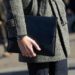 MILAN, ITALY - JANUARY 16: Phil Green of Farfetch wears Acquasutum coat Whistles trousers, a Tudor watch, and black portfolio clutch at Milan Men's Fashion Week Fall/Winter 2016/17 on January 16, 2016 in Milan, Italy. (Photo by Melodie Jeng/Getty Images)