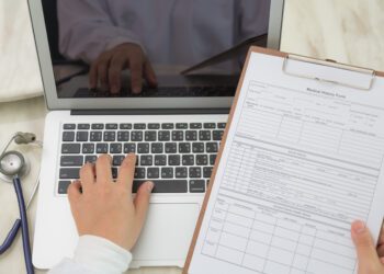Doctor hands typing on laptop keyboard