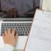 Doctor hands typing on laptop keyboard