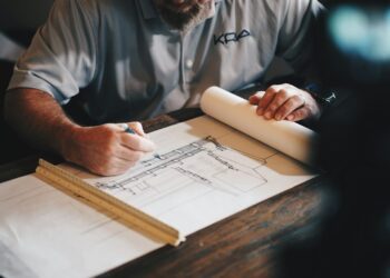 Architect working with plans at a desk; illustrative image for foundation report guide
