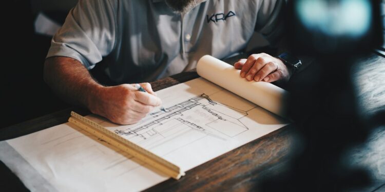 Architect working with plans at a desk; illustrative image for foundation report guide