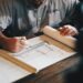 Architect working with plans at a desk; illustrative image for foundation report guide