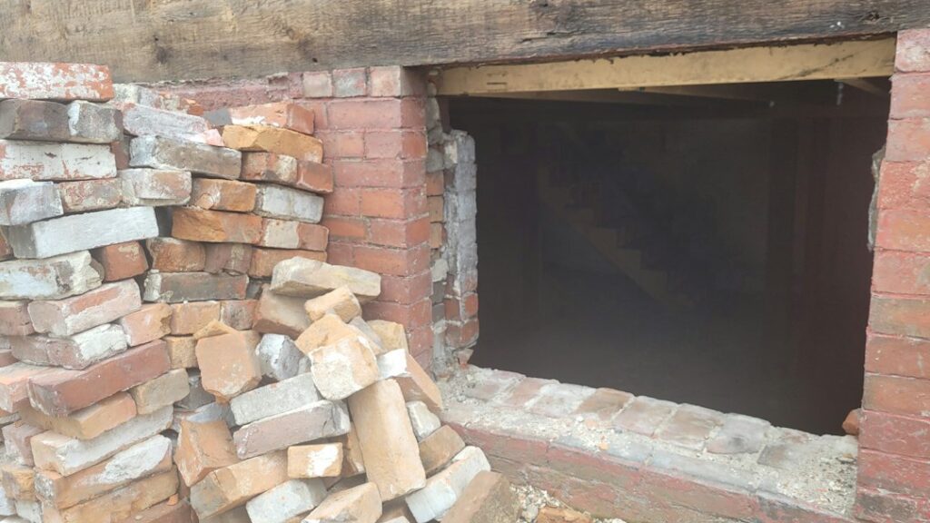 Brick wall and basement opening in a residential building, an illustrative property-condition photo