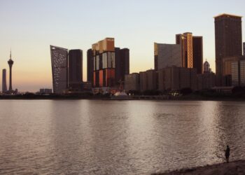 Macau Tower and the city's resort towers across the water at golden hour