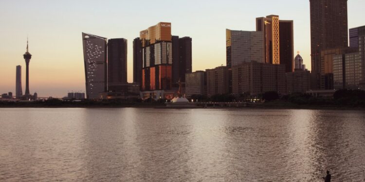 Macau Tower and the city's resort towers across the water at golden hour