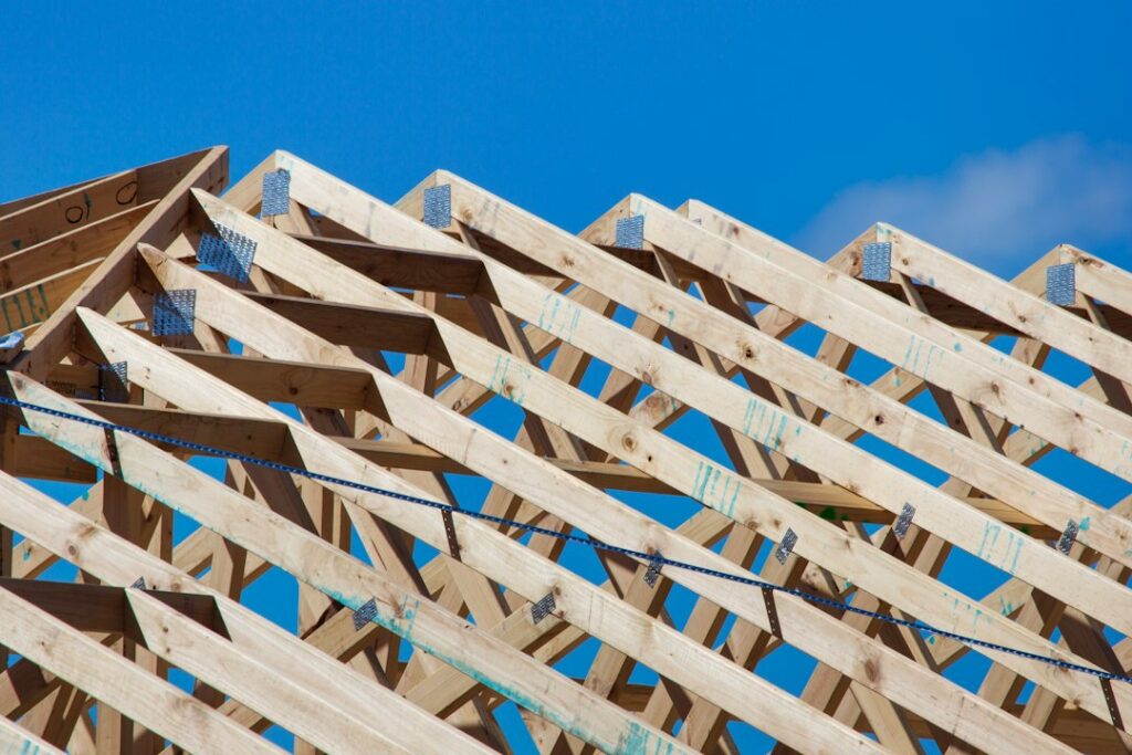 Timber roof trusses on a new home under construction; illustrative image by Troy Mortier