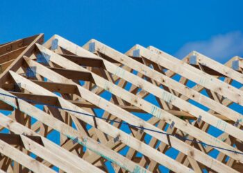 Timber roof trusses on a new home under construction; illustrative image by Troy Mortier