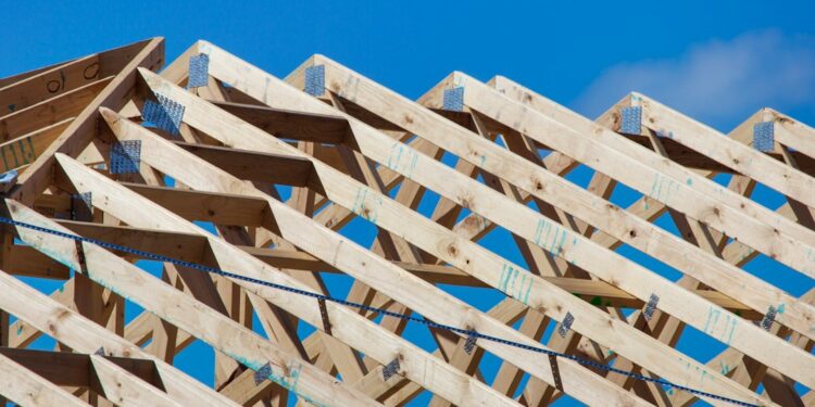 Timber roof trusses on a new home under construction; illustrative image by Troy Mortier
