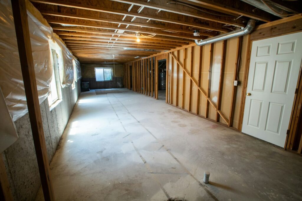 Unfinished basement interior, illustrative image by Real Twin Photos; no visible flood damage