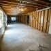 Unfinished basement interior, illustrative image by Real Twin Photos; no visible flood damage