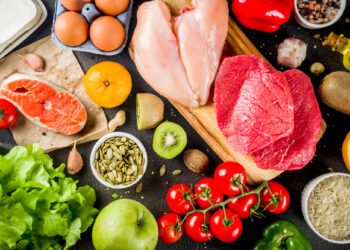 Healthy diet food. Various low fodmap ingredients selection - meat, vegetables, berry, fruit, grains, Trendy healthy lifestyle concept. On dark rusty background copy space top view