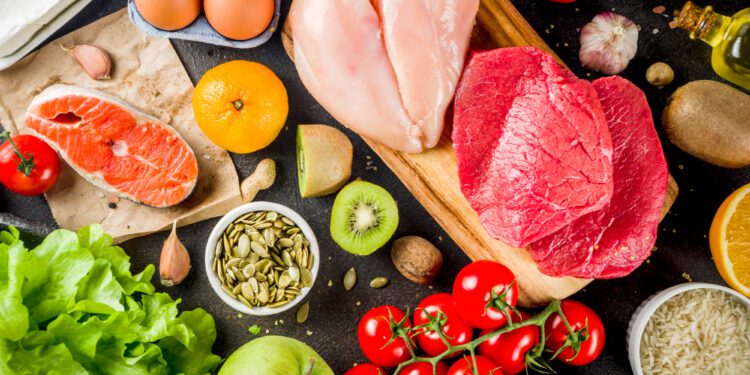 Healthy diet food. Various low fodmap ingredients selection - meat, vegetables, berry, fruit, grains, Trendy healthy lifestyle concept. On dark rusty background copy space top view